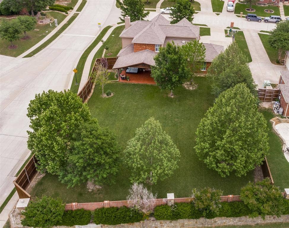 Gargantuan back yard is shaded by established trees, and a recent 9' board-on-board wood fence.