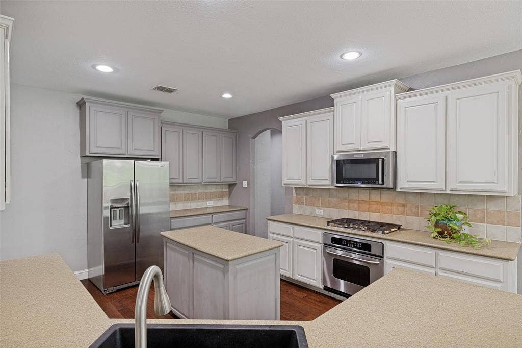 The kitchen is outfitted with stainless-steel appliances, and new sink.