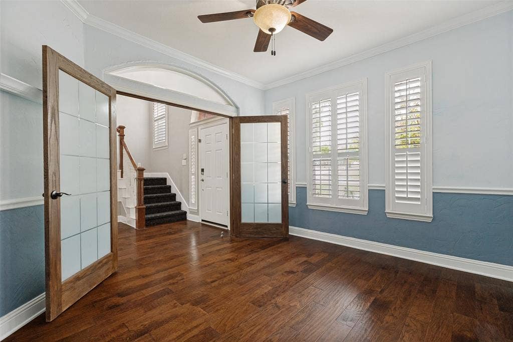 Beautiful glass front French doors adorn the office.