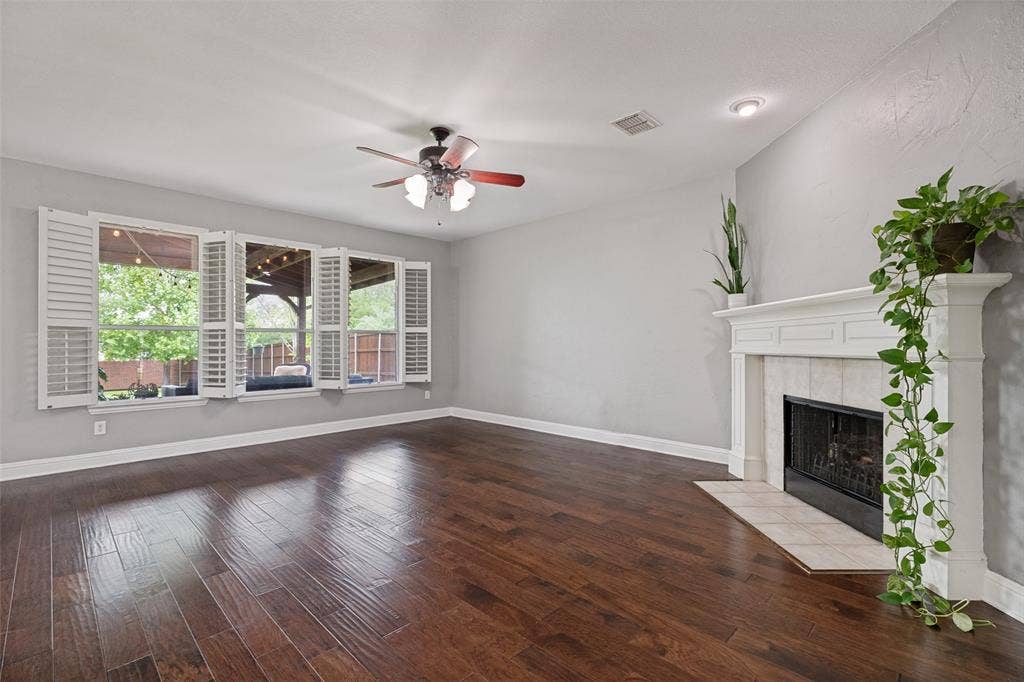 A wall of windows provides natural light to the large living area.