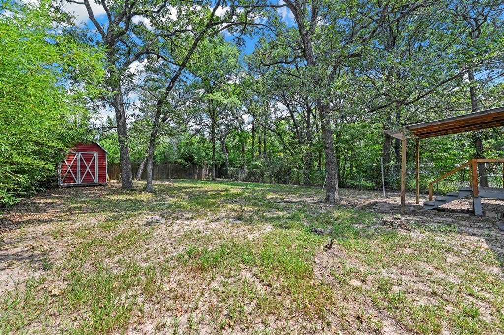214 Wildflower Drive, Gun Barrel City, TX 75156 View of yard featuring a shed