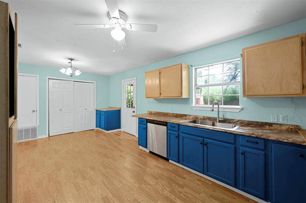 214 Wildflower Drive, Gun Barrel City, TX 75156 Kitchen with hanging light fixtures, dishwasher, sink, light hardwood / wood-style floors, and light brown cabinets