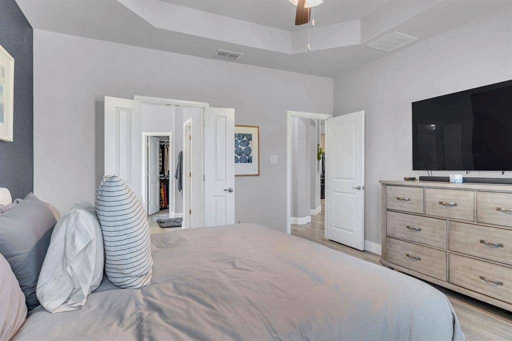 1000 Westwood Lane, Argyle, TX 76226 Room with light grey walls, white trim, and a tray ceiling