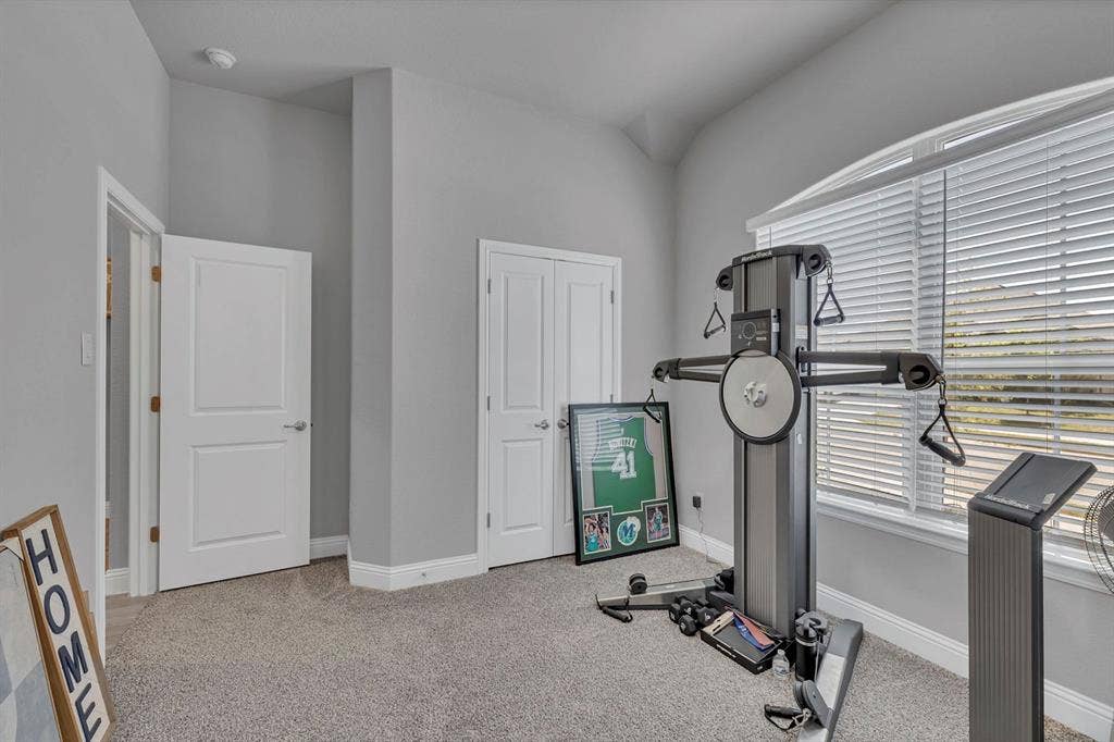 1000 Westwood Lane, Argyle, TX 76226 This versatile room features light gray walls, plush gray carpeting, and multiple white doors