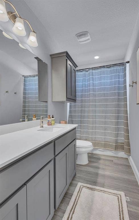 1000 Westwood Lane, Argyle, TX 76226 Bathroom featuring a vanity with a white countertop, a mirror, and grey cabinetry