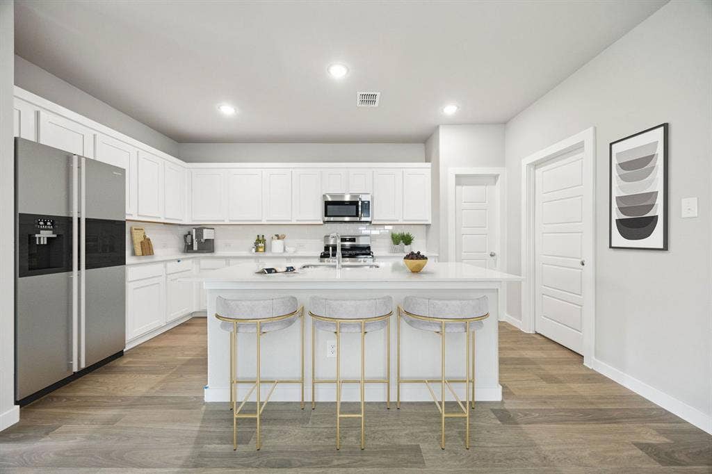 Kitchen in the Hayden home plan by Trophy Signature Homes – REPRESENTATIVE PHOTO