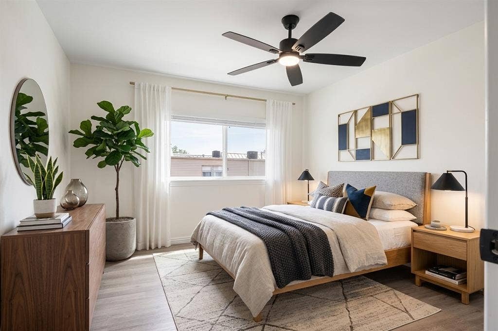 Recessed lighting, wood-finish flooring, a contemporary ceiling fan, and a large window with white drapery