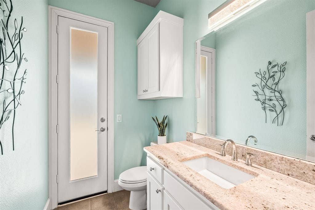 1640 Stillhouse Hollow Drive, Prosper, TX 75078 Half bath that has a door to the rear yard - convenient for guests and outdoor entertaining access.