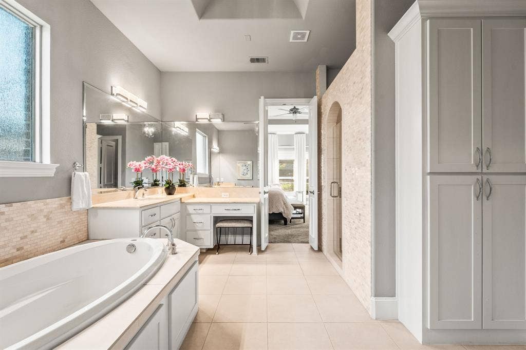 1640 Stillhouse Hollow Drive, Prosper, TX 75078 Around the corner in the primary bathroom is a linen cabinet and the primary bedroom large closet - refer to floor plan for the visual layout. The closet opens to the large laundry room.
