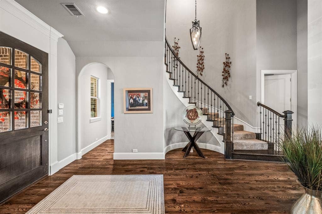 1640 Stillhouse Hollow Drive, Prosper, TX 75078 Entry - note the handsome wood floors & front door, stair case that compliments the surrounding rooms. The arch opening by the door leads to an office.