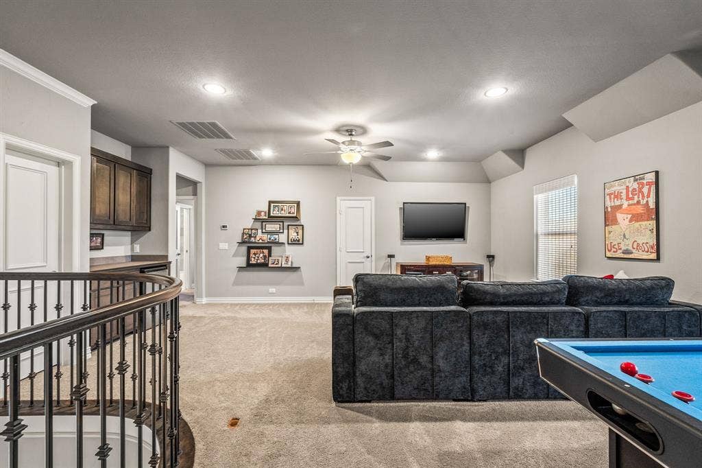 1640 Stillhouse Hollow Drive, Prosper, TX 75078 The second level opens into a double sized game room - living area. Spacious to fit a pool table and provides an ideal setting for televisions, video games, etc. To the far left by the staircase is a door that leads to a large storage closet.