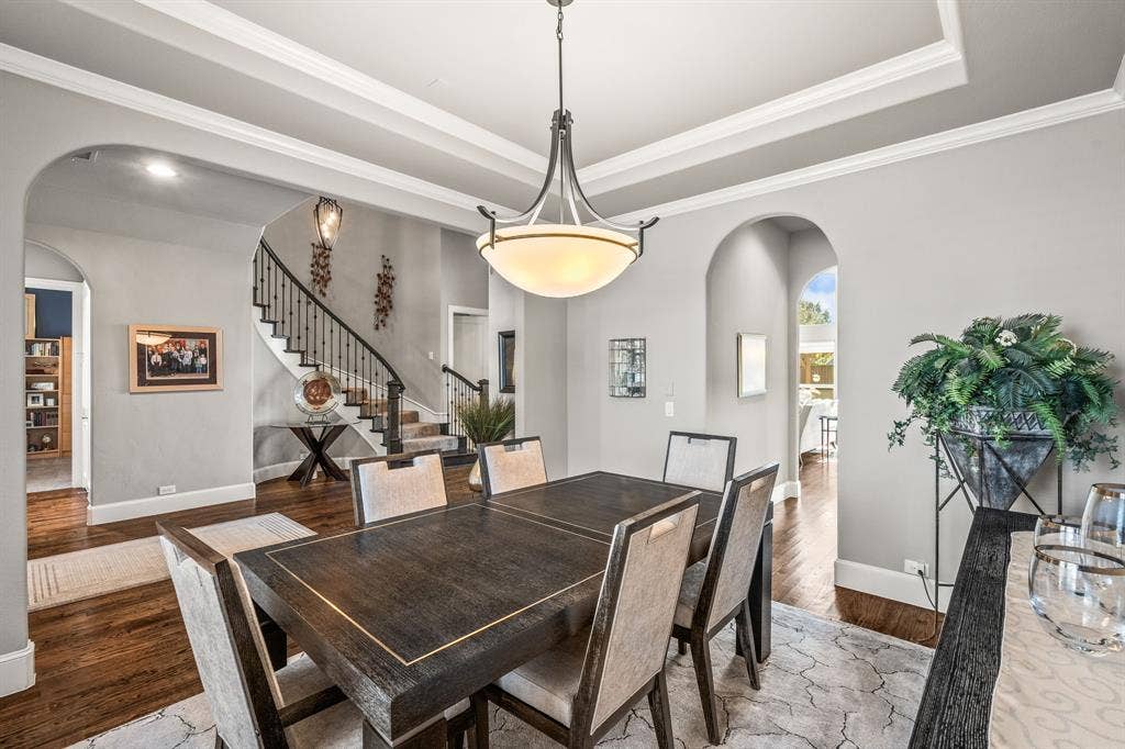 1640 Stillhouse Hollow Drive, Prosper, TX 75078 Tray ceiling in the dining area which opens to the kitchen. Plenty of room to fit a large dining room set. There is a butler's pantry through the arch open area.