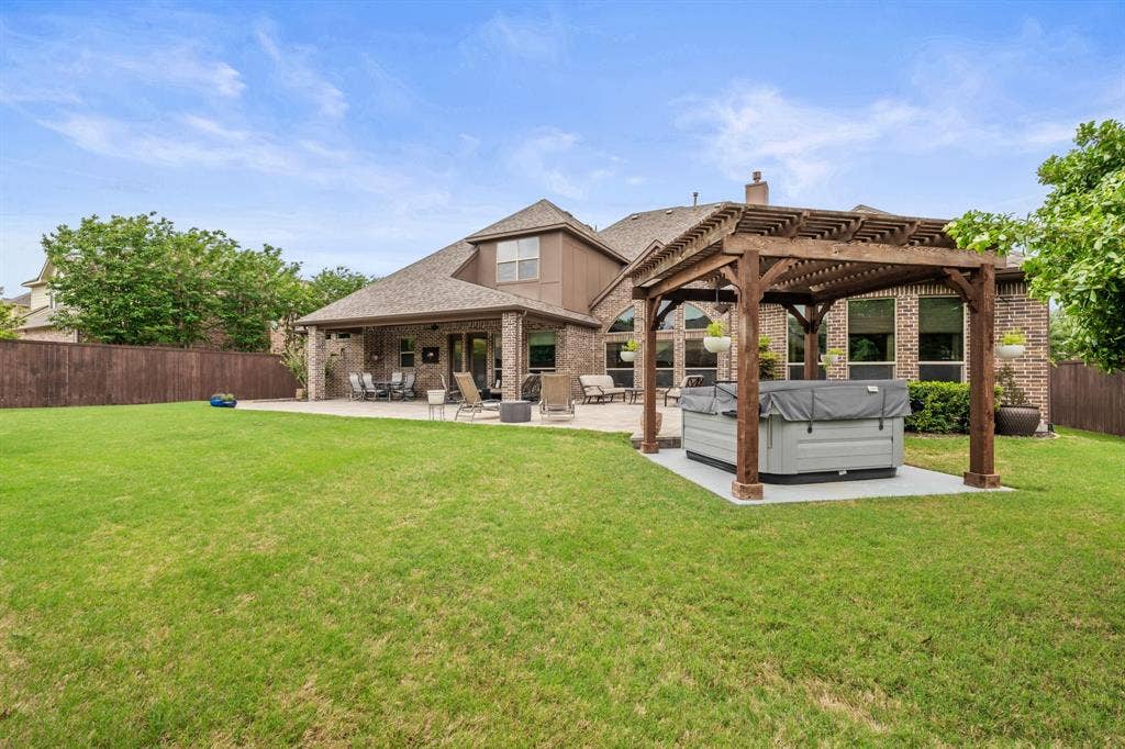 1640 Stillhouse Hollow Drive, Prosper, TX 75078 Incredible outdoor entertaining area with a large covered patio which melts into an open patio ideal for a firepit and hours of relaxation. A pergola covered large spa with many features conveys with the property.