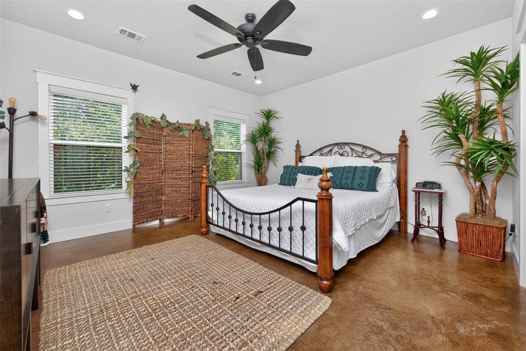 6371 Mill Run Road, Athens, TX 75751 This bedroom features a ceiling fan, recessed lighting, and two windows providing natural light