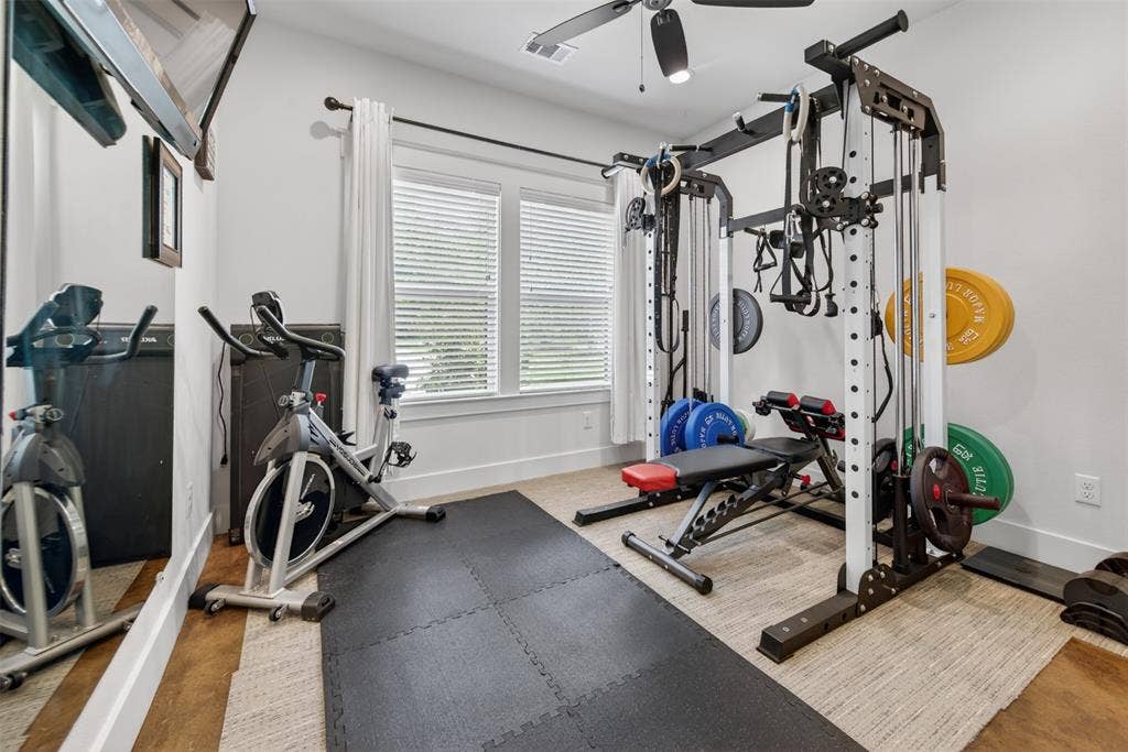 6371 Mill Run Road, Athens, TX 75751 Dedicated fitness area with ample natural light from two windows, featuring a ceiling fan, and a neutral color palette