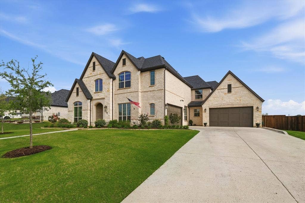 Stone and brick exterior with dark shingle roofing and gabled architectural details