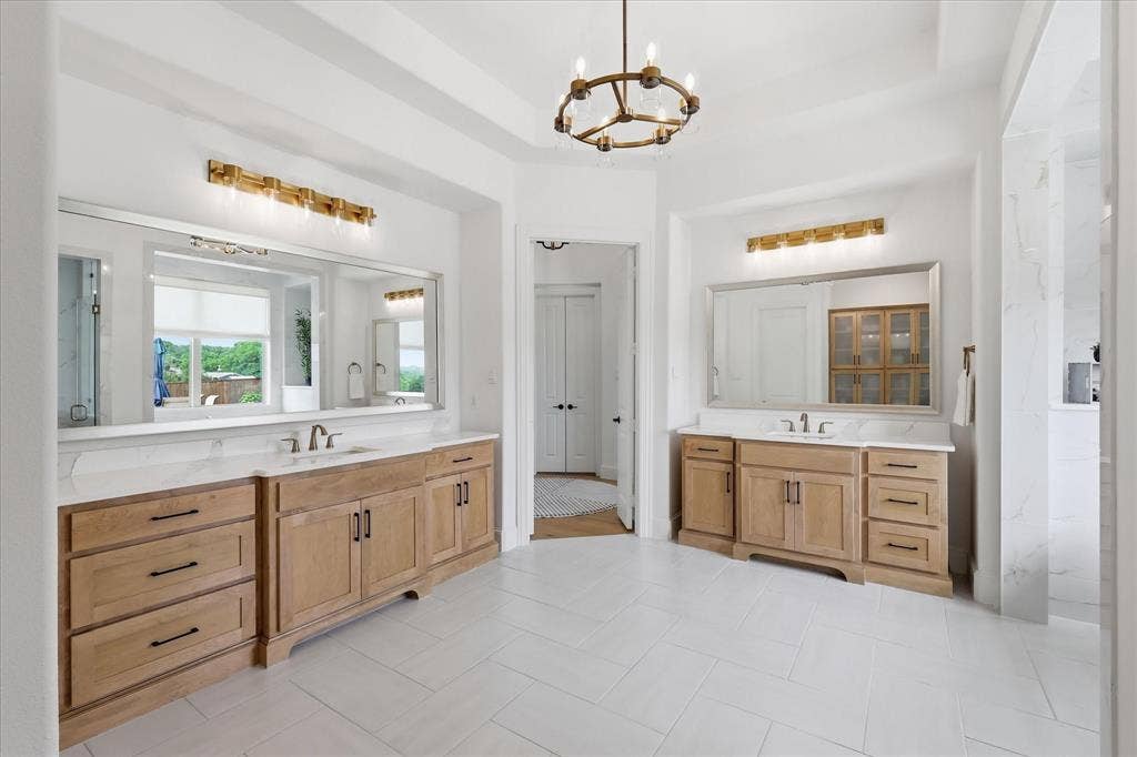 Dual wood-finish vanities with white countertops and undermount sinks