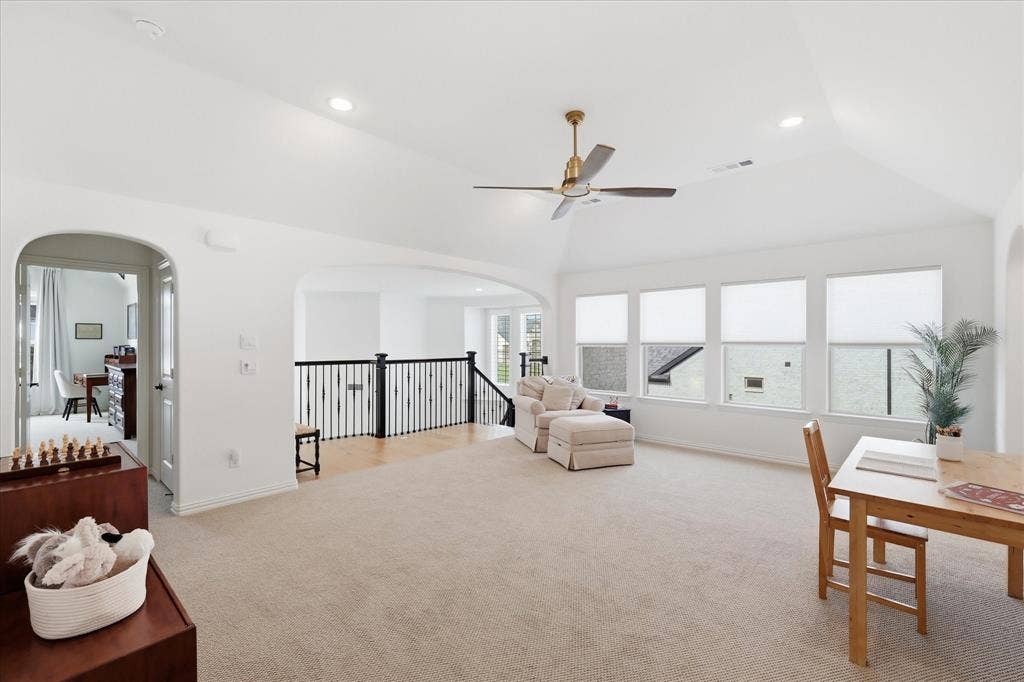 Spacious room featuring neutral wall paint, recessed lighting, and light-toned carpet flooring