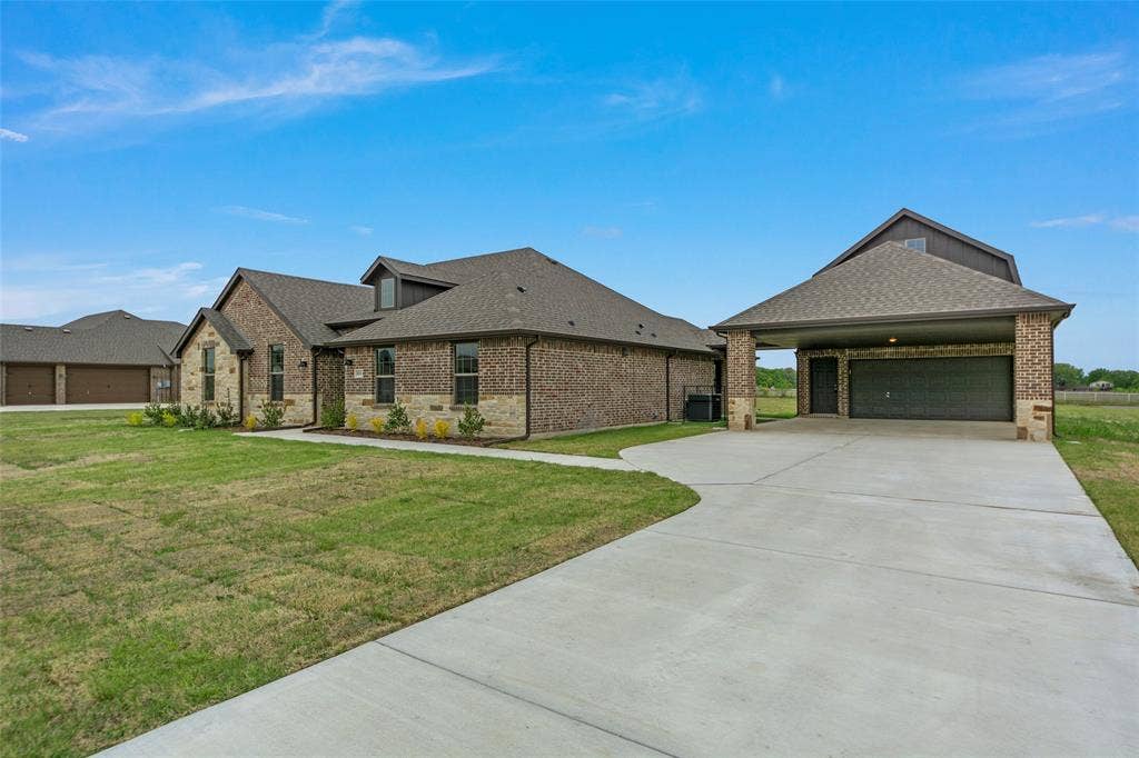 18310 CHIPPEWA Court, Terrell, TX 75160 Brick exterior with stone accents, a gabled roofline, and dormer windows