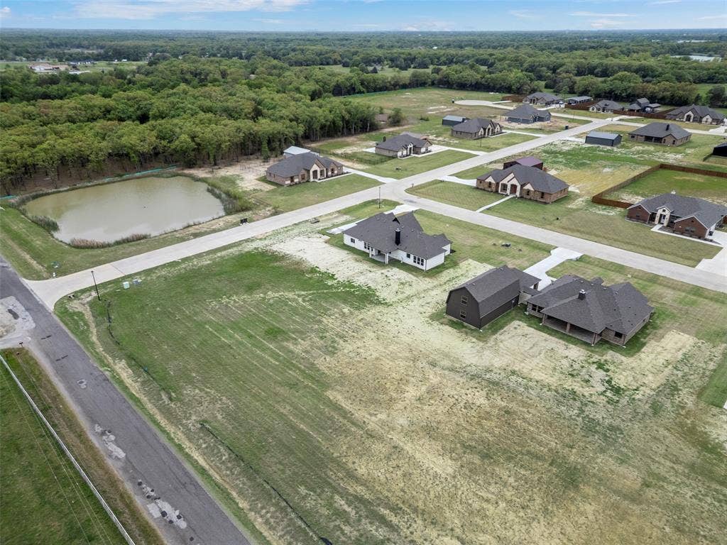 18310 CHIPPEWA Court, Terrell, TX 75160 Newly constructed residential development featuring a private pond and surrounding wooded areas