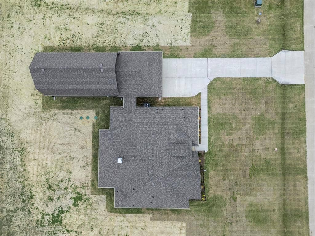 18310 CHIPPEWA Court, Terrell, TX 75160 Aerial view showcasing a residential property with a main house and an accessory structure featuring dark gray shingle roofing