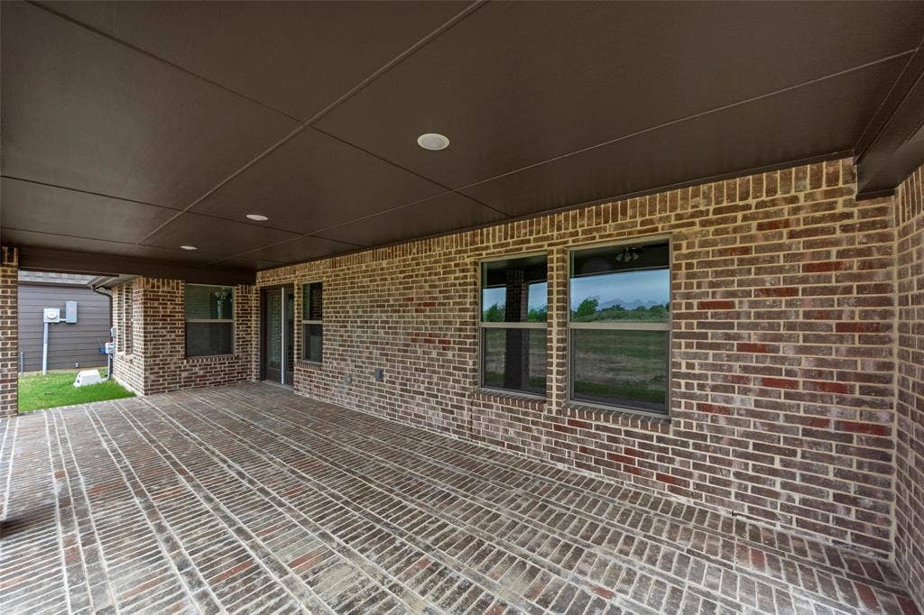 18310 CHIPPEWA Court, Terrell, TX 75160 Covered outdoor patio featuring brick flooring, recessed lighting, and a dark ceiling