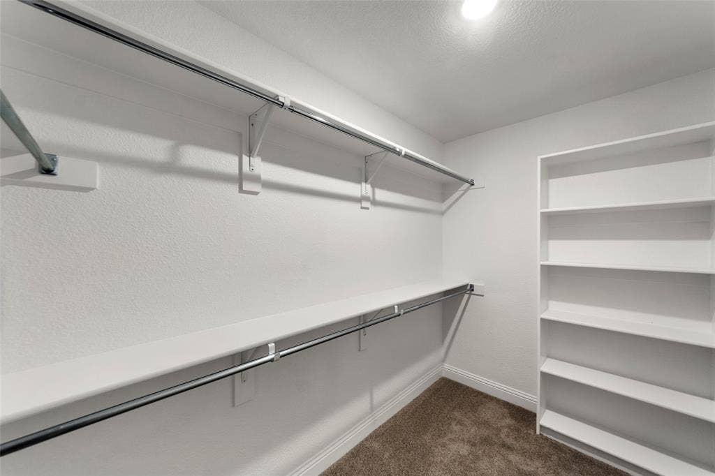 18310 CHIPPEWA Court, Terrell, TX 75160 Walk-in closet featuring white walls, chrome hanging rods, and built-in shelving