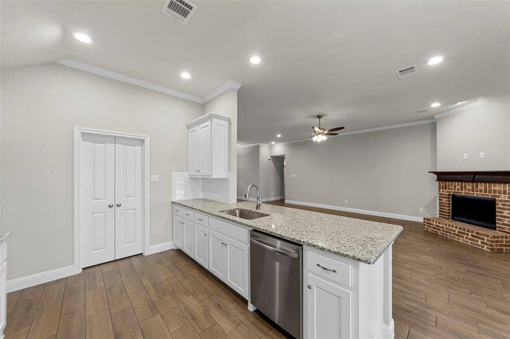 18310 CHIPPEWA Court, Terrell, TX 75160 Kitchen island with a granite countertop, undermount sink, and stainless steel dishwasher