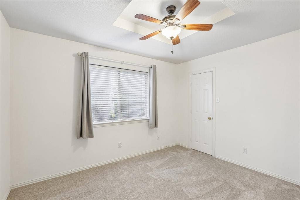 4124 Cory Lee Court, Arlington, TX 76015 Recessed ceiling detail with a wood-finish ceiling fan, neutral wall paint, window with blinds, and light-toned carpeting