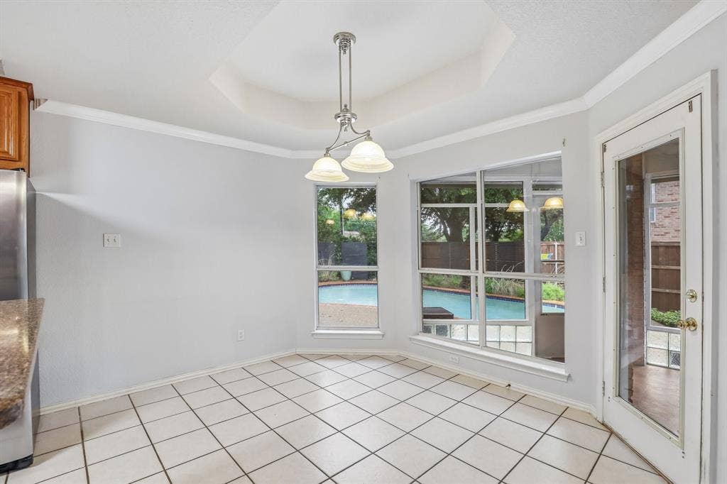 4124 Cory Lee Court, Arlington, TX 76015 Dining area with white tile flooring and a tray ceiling