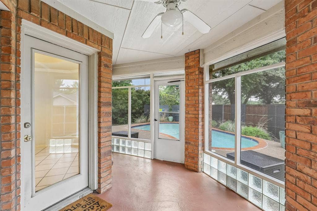 4124 Cory Lee Court, Arlington, TX 76015 Screened porch featuring brick accents, overhead ceiling fan, and access to a curvilinear swimming pool