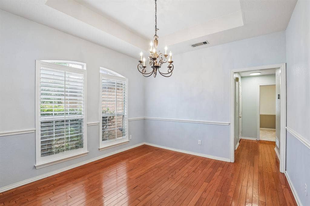 4124 Cory Lee Court, Arlington, TX 76015 Room featuring wood-finish flooring and a tray ceiling