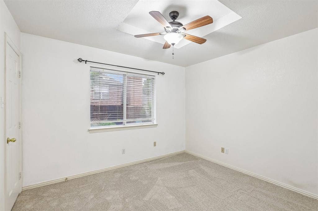4124 Cory Lee Court, Arlington, TX 76015 Bright room featuring neutral-toned carpet, white walls, and a window with blinds