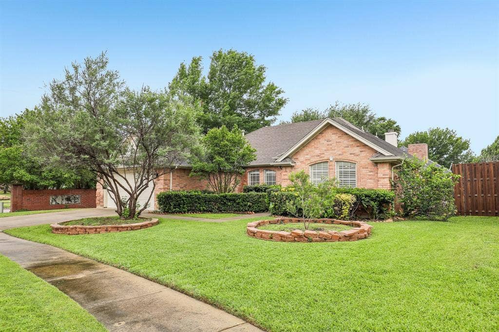 4124 Cory Lee Court, Arlington, TX 76015 Brick exterior residence featuring a gabled roofline and multiple windows