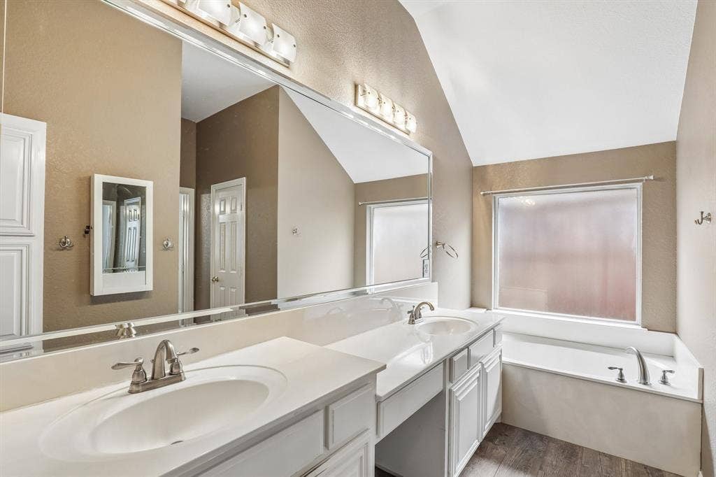 4124 Cory Lee Court, Arlington, TX 76015 Spacious bathroom featuring a double vanity with white cabinetry, integrated sinks, and brushed nickel faucets