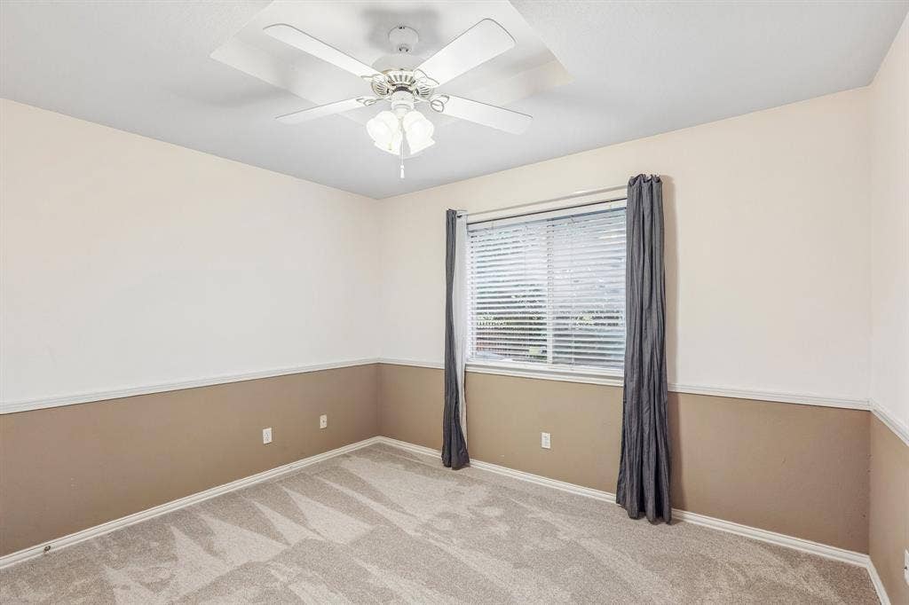 4124 Cory Lee Court, Arlington, TX 76015 Interior room featuring neutral-toned walls with a two-tone paint treatment, a ceiling fan with integrated lighting, a window with horizontal blinds, and grey carpeting