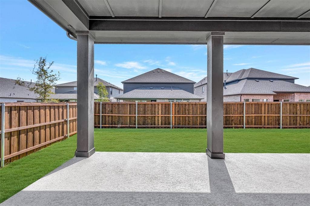 1611 Cedarberry Drive, Northlake, TX 76226 Expansive concrete patio with a covered outdoor area, offering access to a private backyard with a wood fence and green lawn