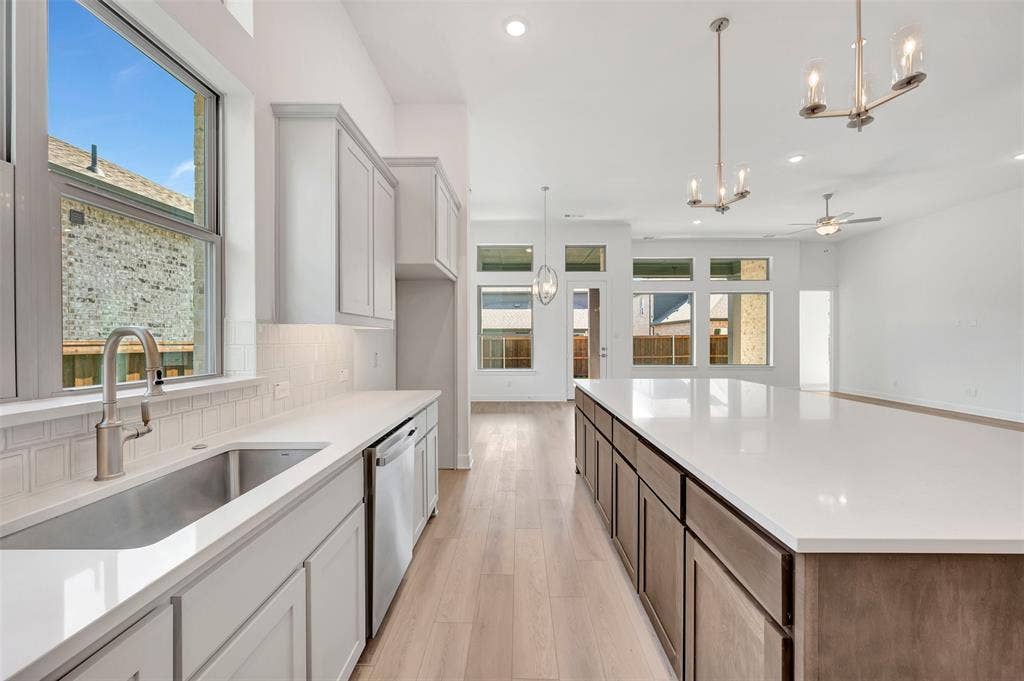 1611 Cedarberry Drive, Northlake, TX 76226 Kitchen featuring stainless steel sink, light-toned cabinetry, light countertops, and wood-finish flooring