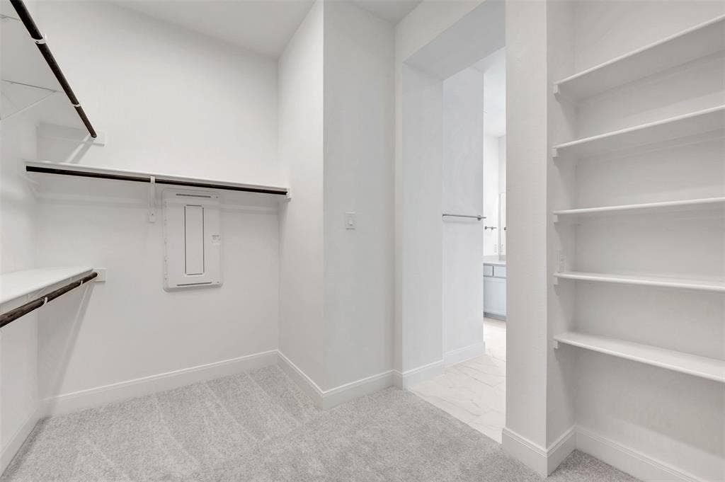 1611 Cedarberry Drive, Northlake, TX 76226 Walk-in closet with built-in shelving, hanging rods, and light gray carpeting