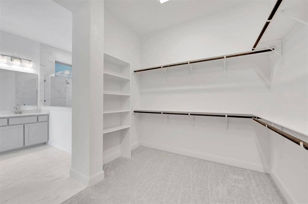 1611 Cedarberry Drive, Northlake, TX 76226 Walk-in closet with built-in shelving, hanging rods, and carpet flooring