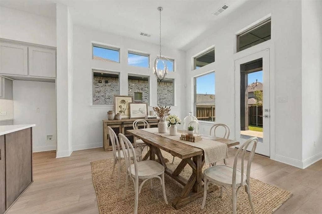 1611 Cedarberry Drive, Northlake, TX 76226 Expansive dining area featuring wood-finish flooring, high ceilings, large windows, and a glass-paneled door