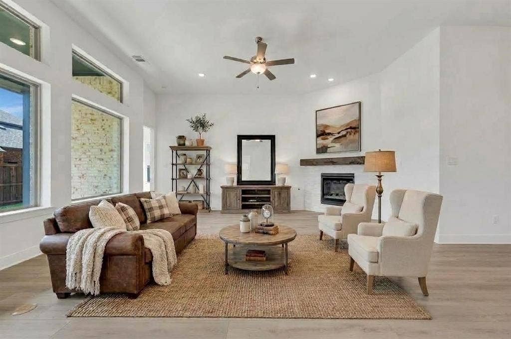 1611 Cedarberry Drive, Northlake, TX 76226 Living area featuring high ceilings, a fireplace with a wood mantel, multiple windows, recessed lighting, and wood-finish flooring