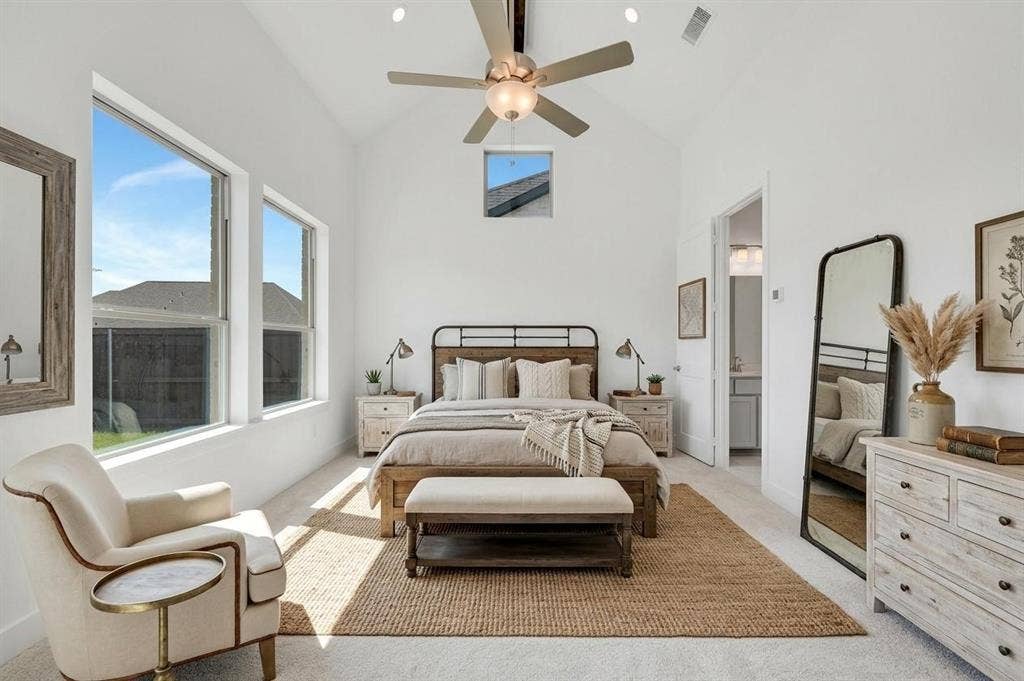 1611 Cedarberry Drive, Northlake, TX 76226 Vaulted ceiling with a ceiling fan, abundant natural light from multiple windows, and a doorway opening to an additional space