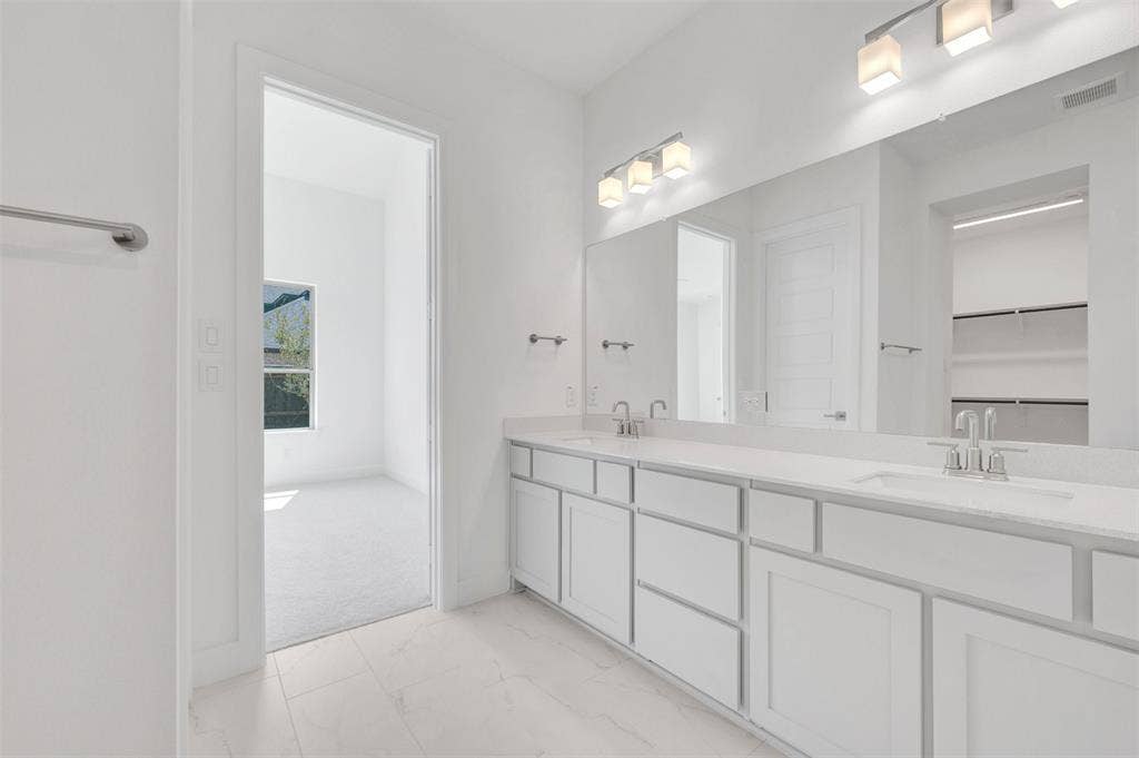1611 Cedarberry Drive, Northlake, TX 76226 Dual vanity with integrated sinks, expansive counter space, white cabinetry, and a full-width mirror