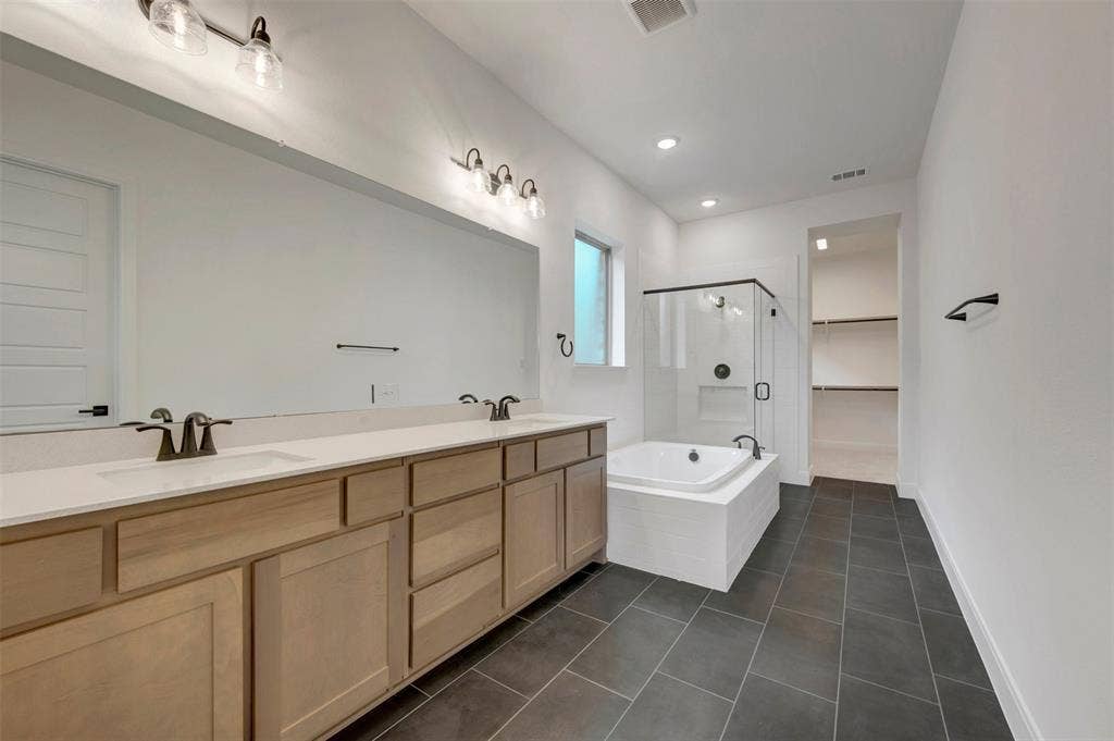 1605 Cedarberry Drive, Northlake, TX 76226 Double vanity with light wood-finish cabinetry and white countertops