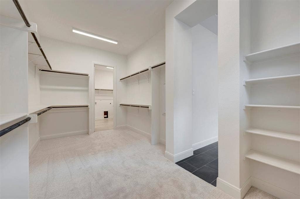 1605 Cedarberry Drive, Northlake, TX 76226 Expansive closet with extensive shelving and hanging rods, light-toned carpeting, and a recessed ceiling light fixture