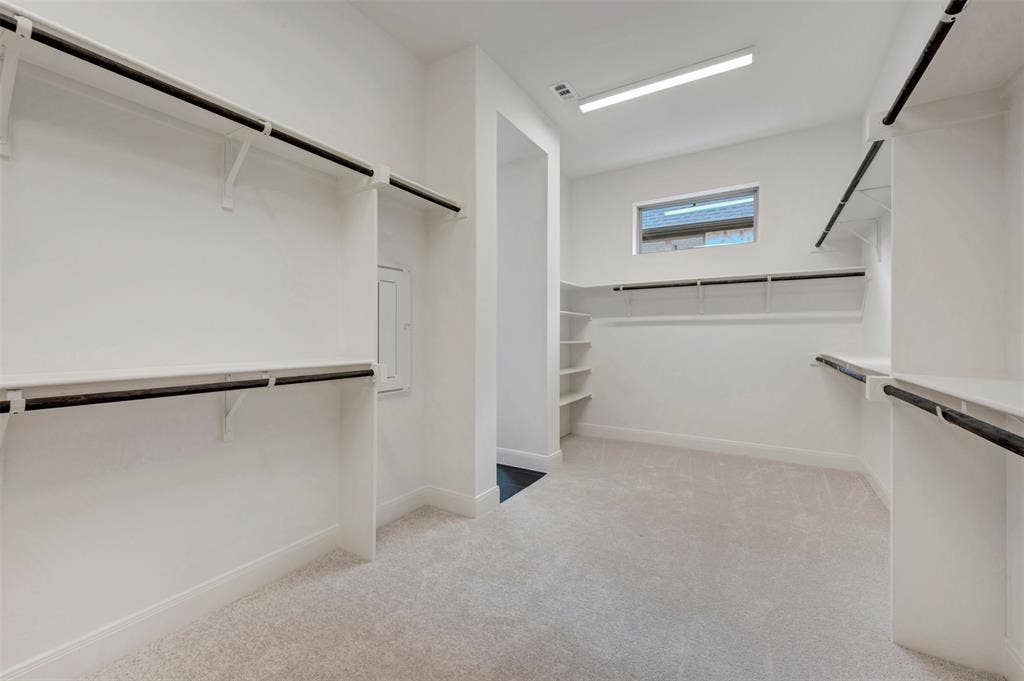 1605 Cedarberry Drive, Northlake, TX 76226 Spacious walk-in closet featuring white built-in shelving, black hanging rods, light-colored carpeting, a high-set window, and recessed lighting