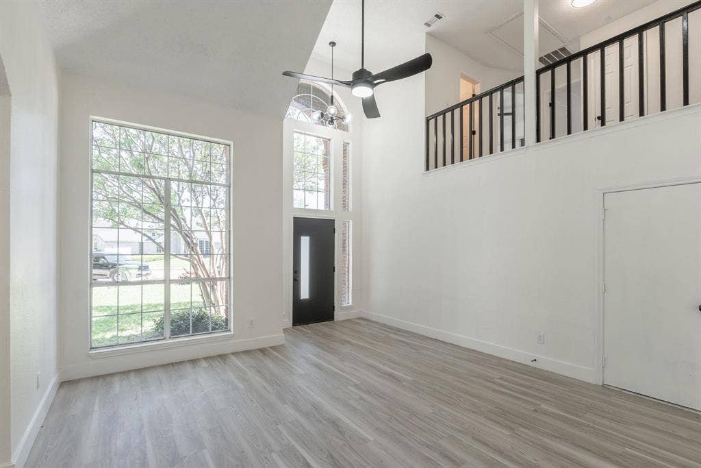 Two-story living area featuring high ceilings and wood-finish flooring