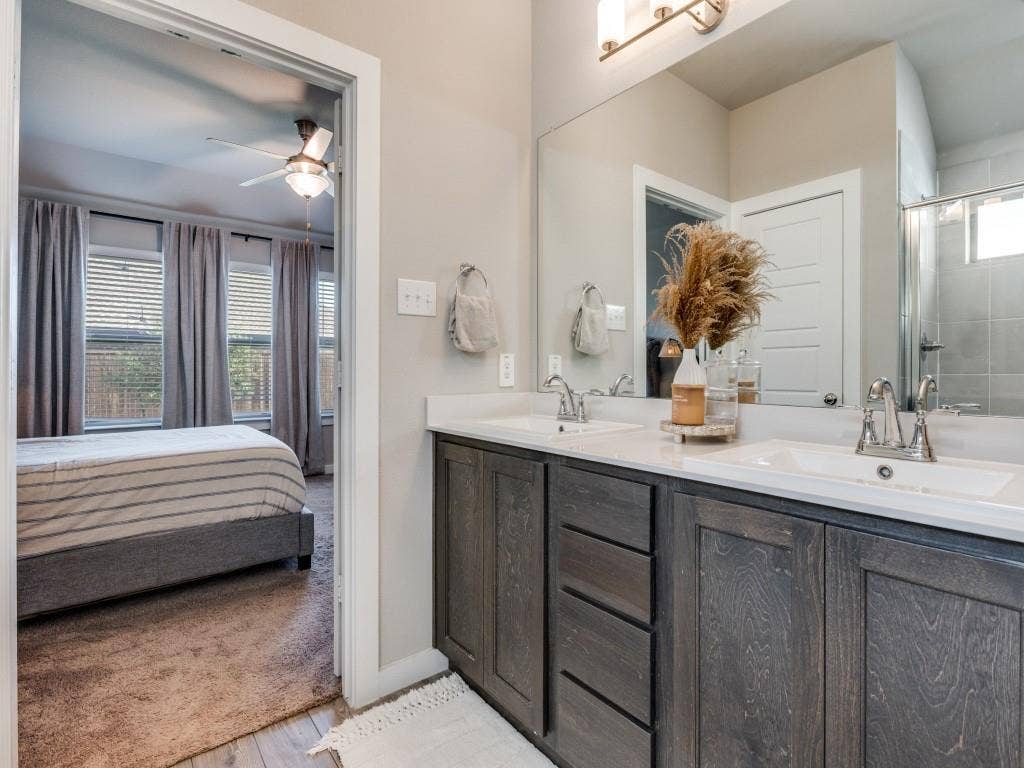 626 Congressional Avenue, Red Oak, TX 75154 Bathroom vanity featuring dual undermount sinks, white countertops, and dark wood-finish cabinetry