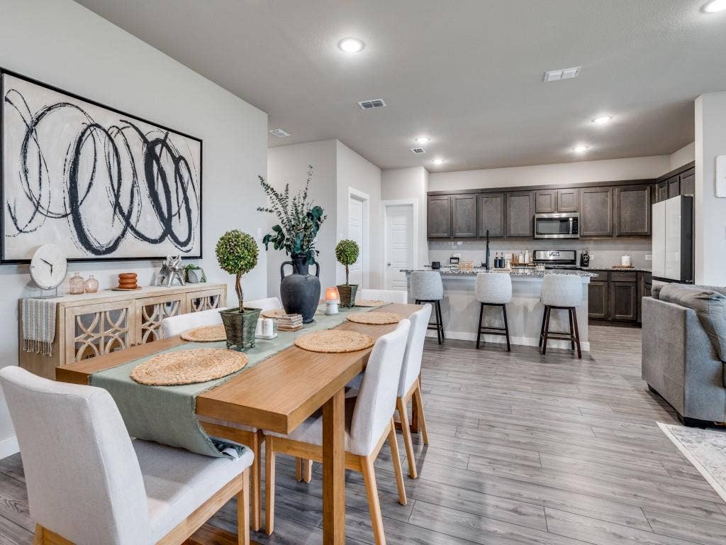 626 Congressional Avenue, Red Oak, TX 75154 Open-concept living area featuring wood-finish flooring, recessed lighting, and a dining space with a light wood table